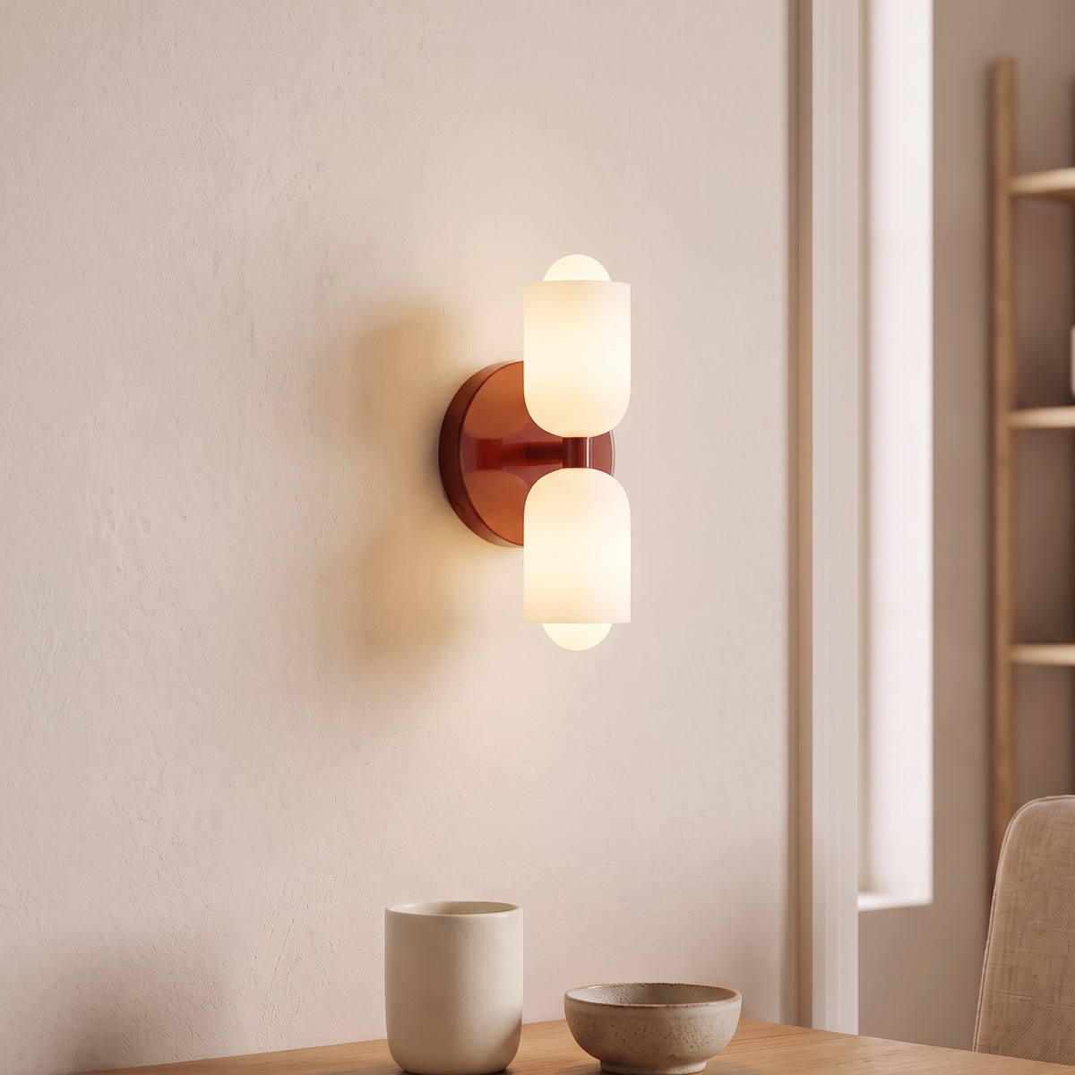 Claret red double wall sconce with opal shades above an oak desk