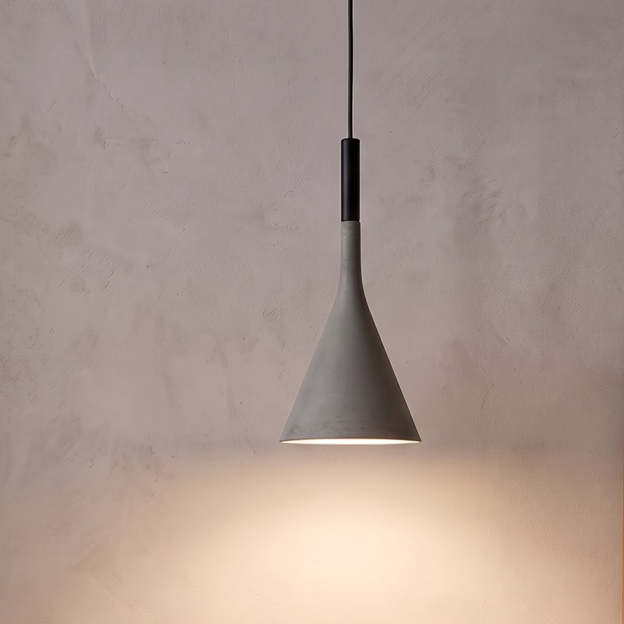 Grey cone pendant light glowing over an oak nightstand in a bedroom