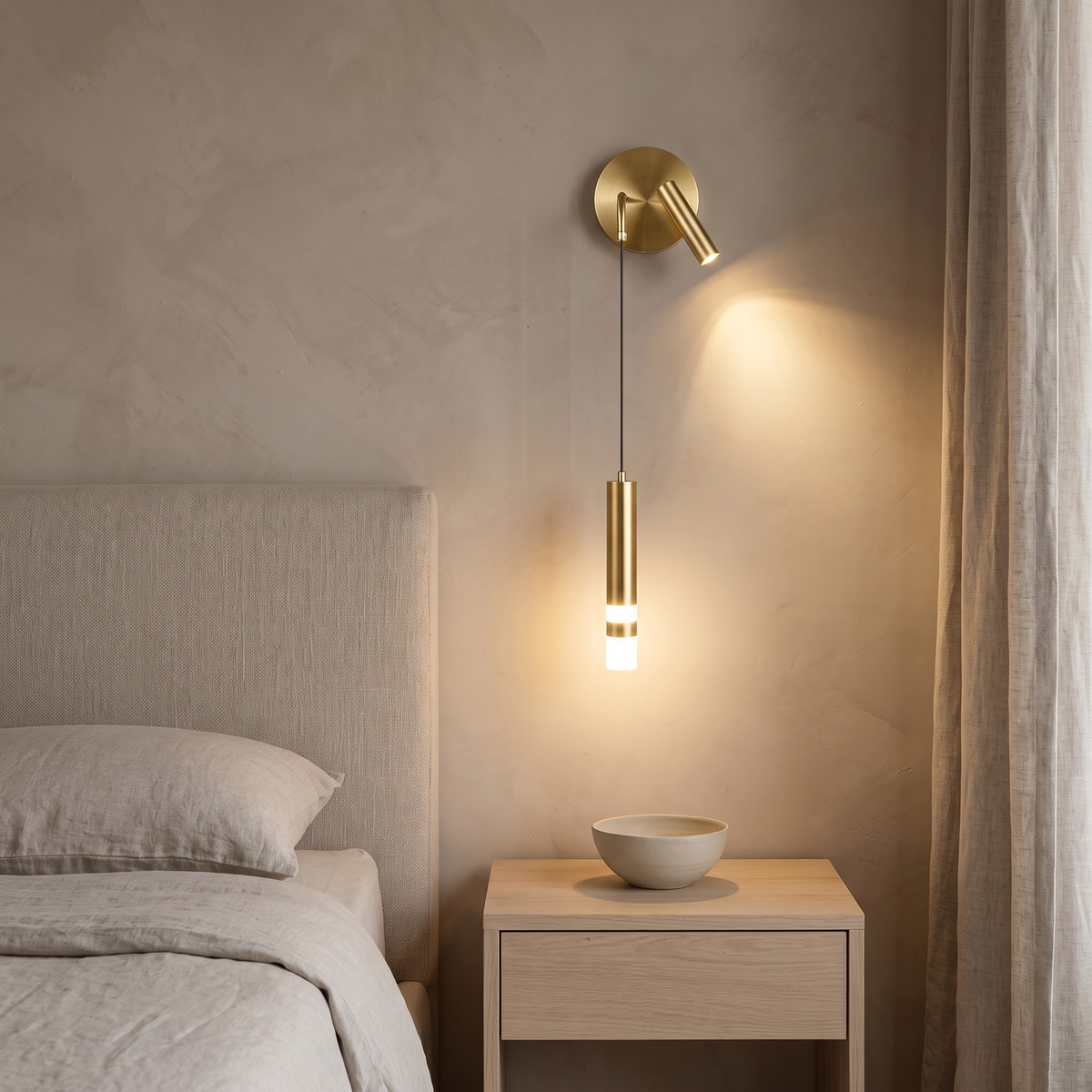 Brushed gold bedside wall light with pendant tube in a clay-walled bedroom