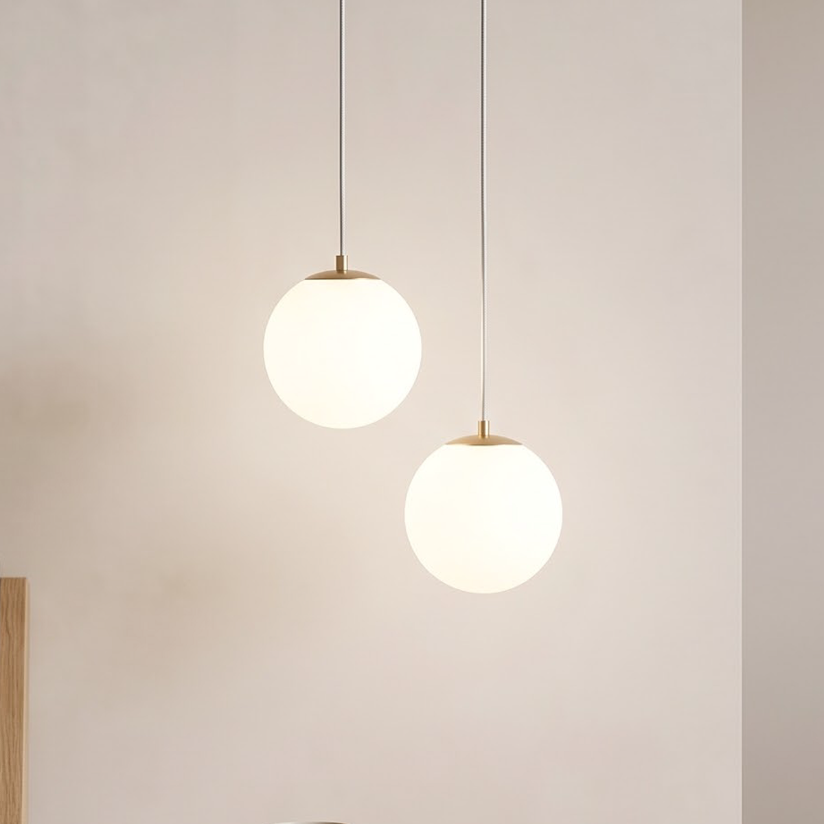 Brass double opal globe pendant glowing beside an oak nightstand