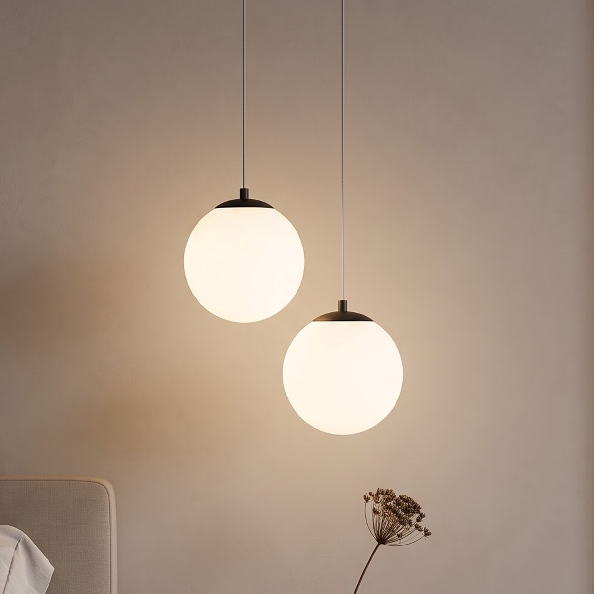 Black double globe pendant light beside a walnut nightstand at dusk