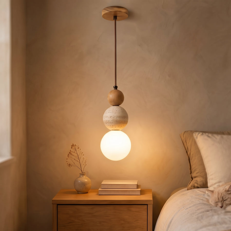 Travertine and opal glass pendant light in light oak above a nightstand