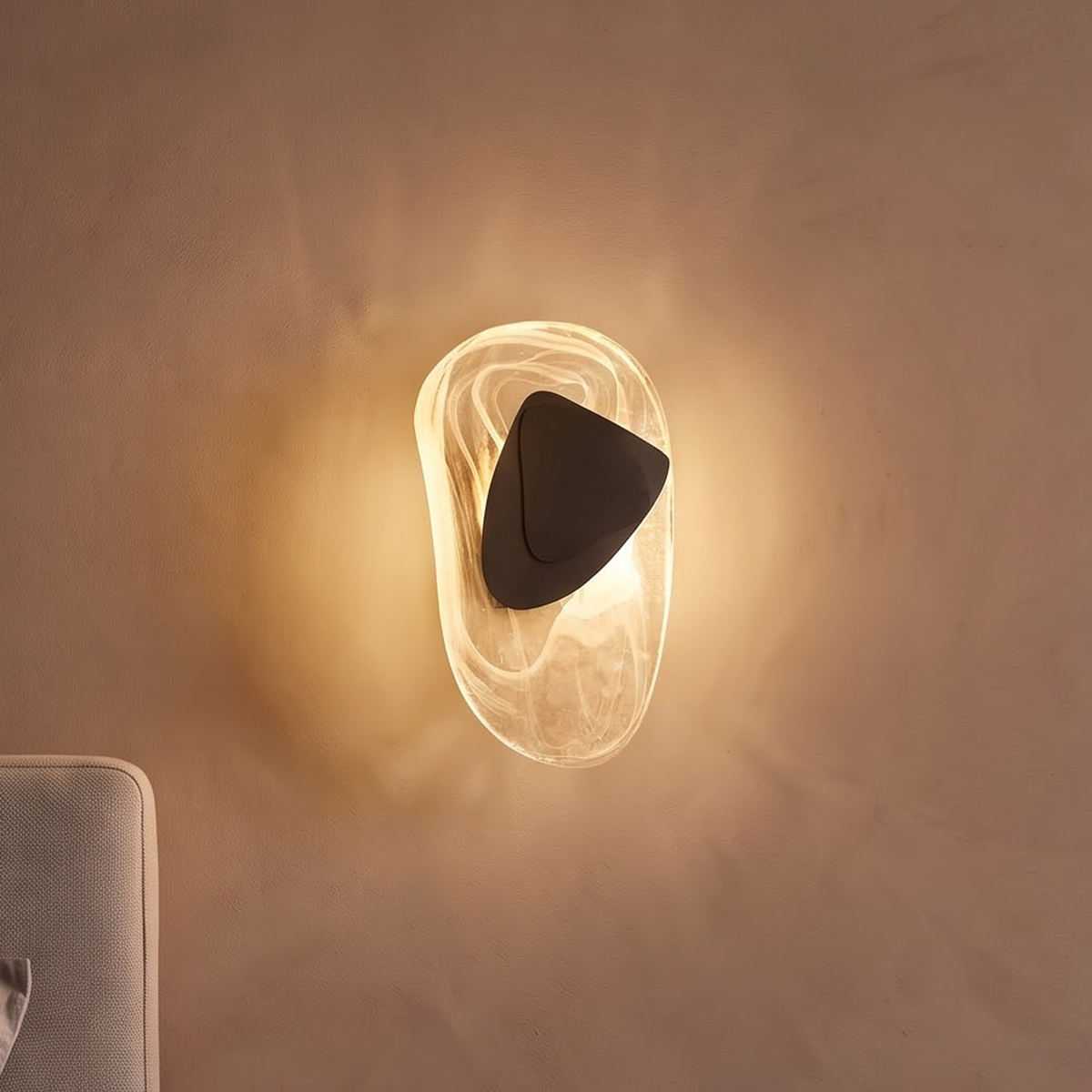 Swirled glass wall light with black plate above a walnut nightstand