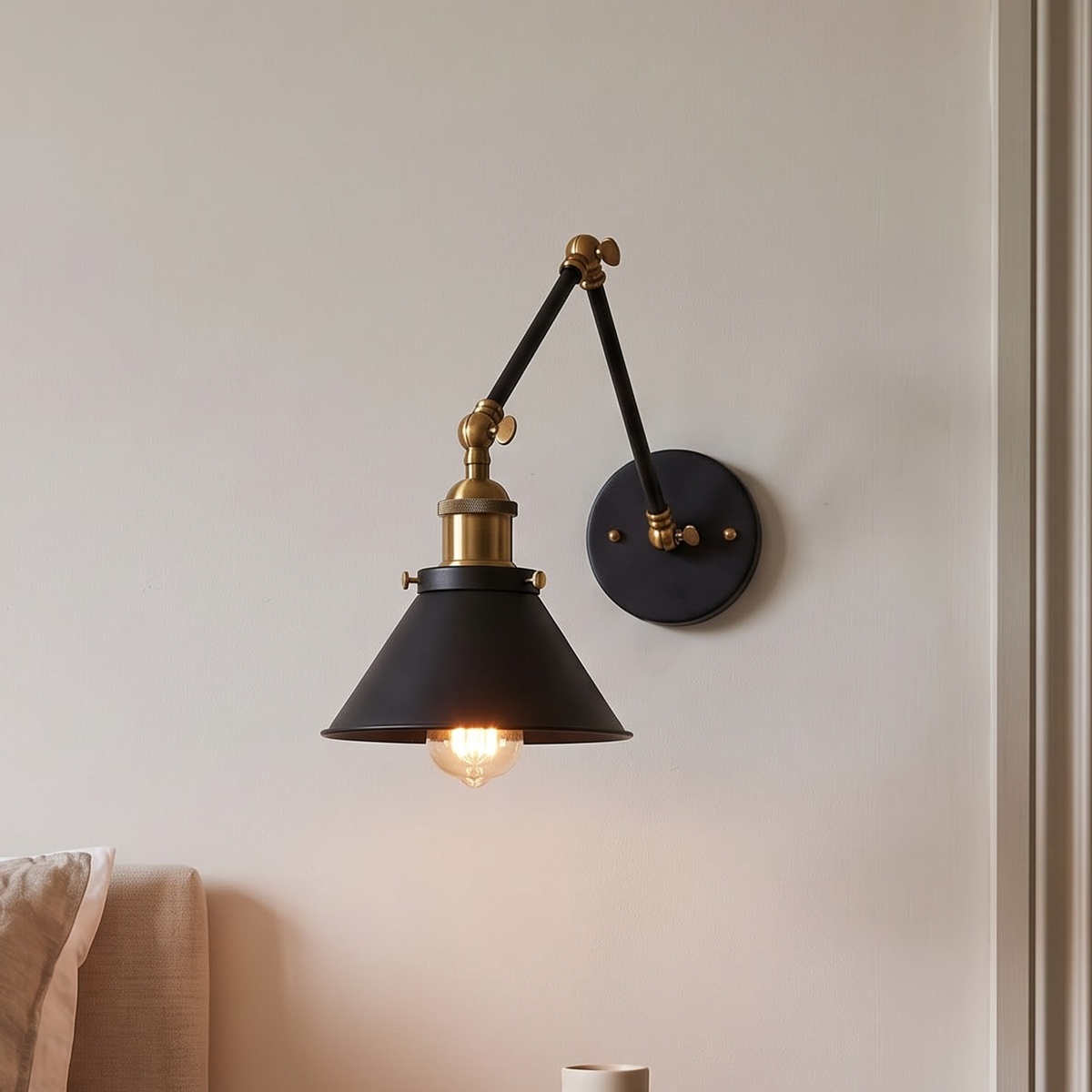 Black swing-arm wall lamp with brass socket above a nightstand