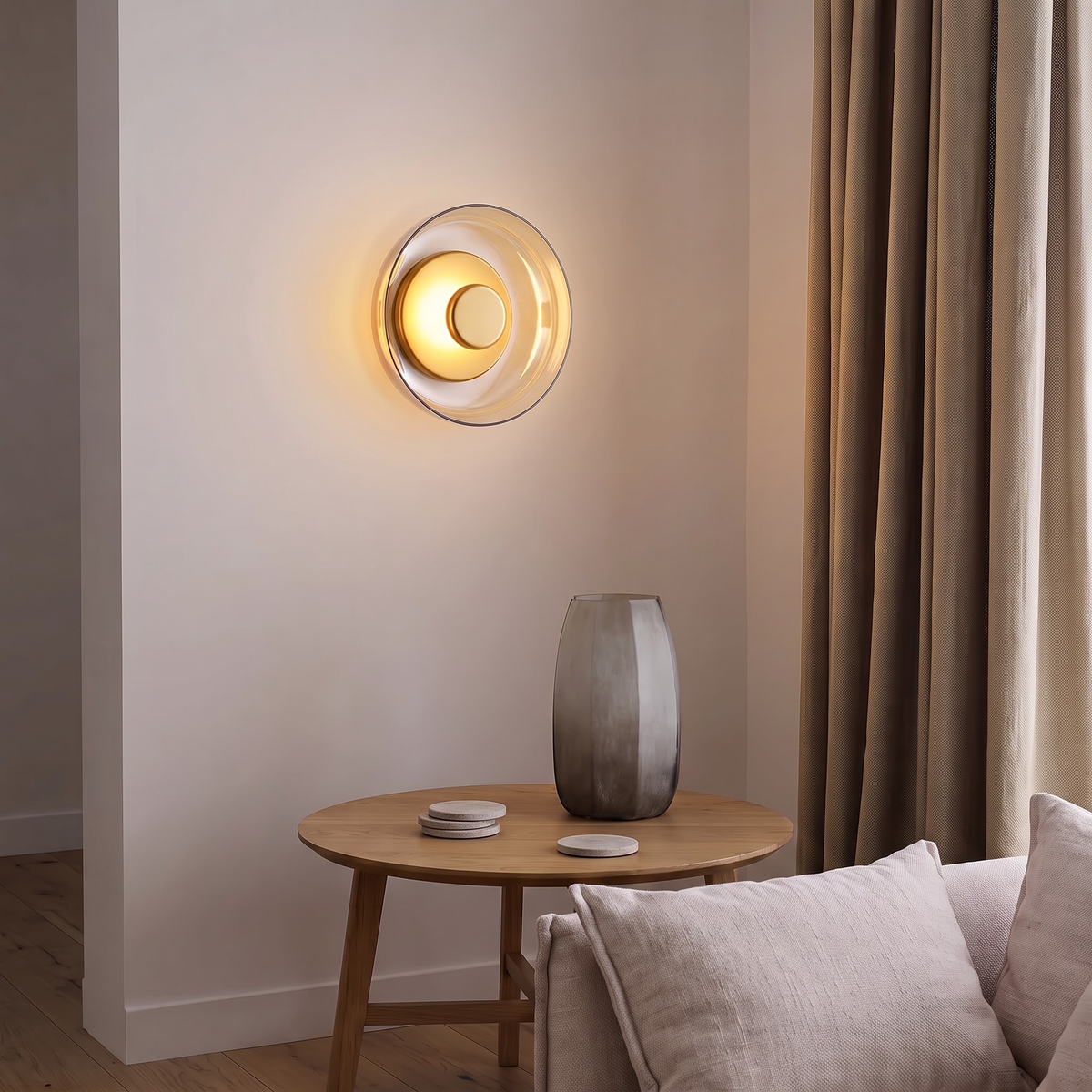 Champagne glass round wall sconce beside linen curtains in a living room