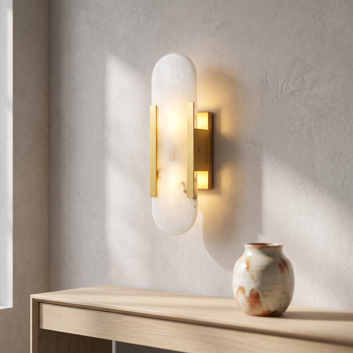 White marble and gold wall sconce above an oak console in a hallway
