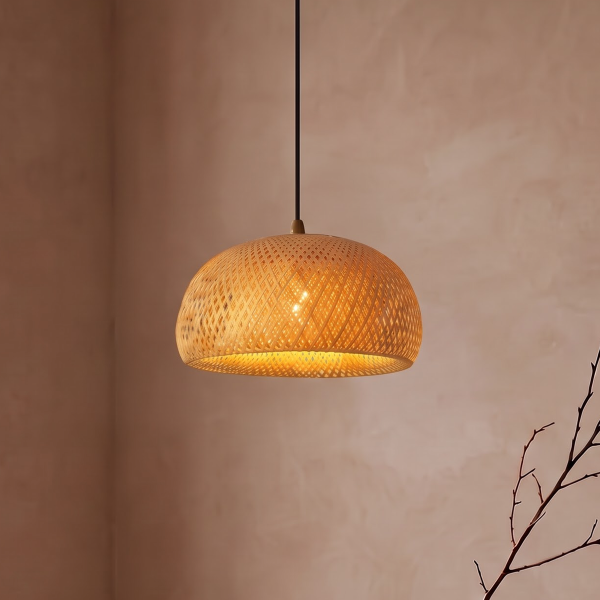 Woven bamboo dome pendant glowing amber above an oak dining table